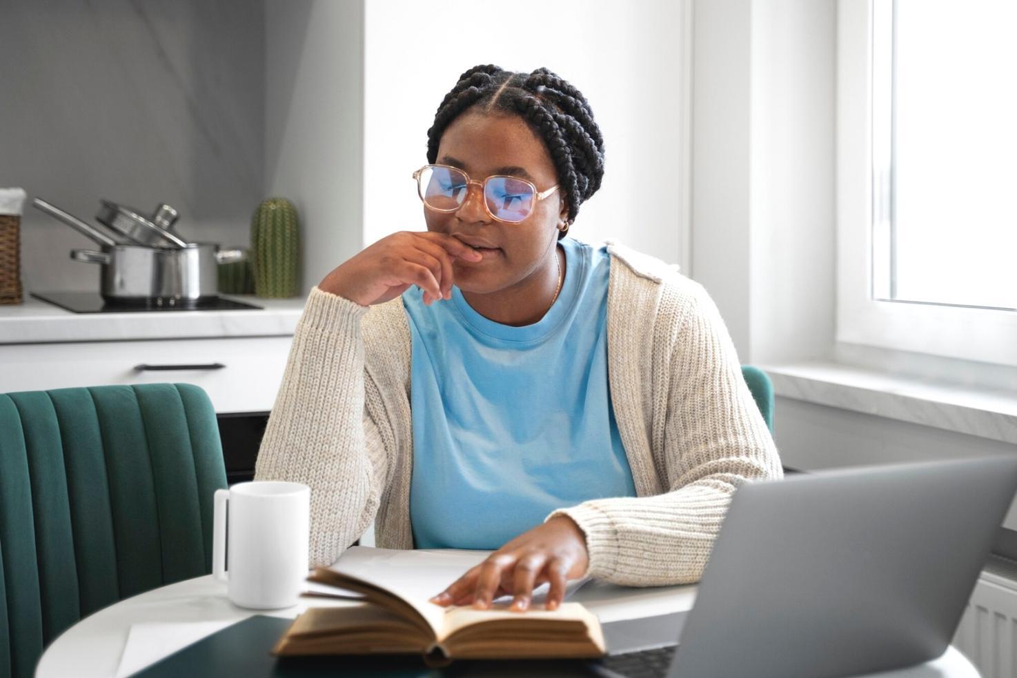 Home office setup with financial charts and study materials